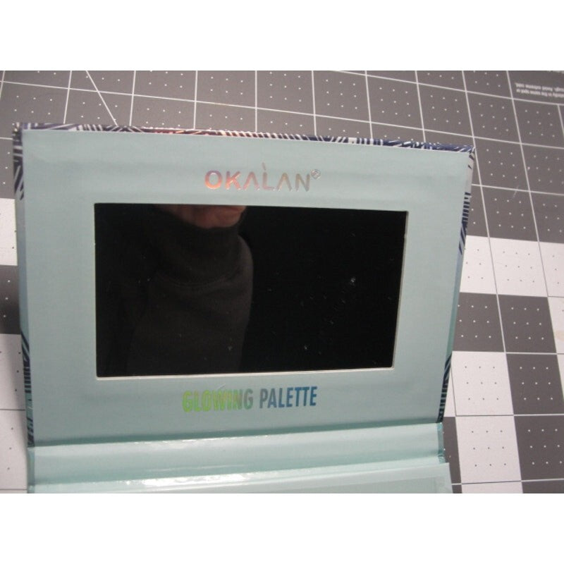 Okalan Glowing Face Palette B shimmers kit in a holographic packaging