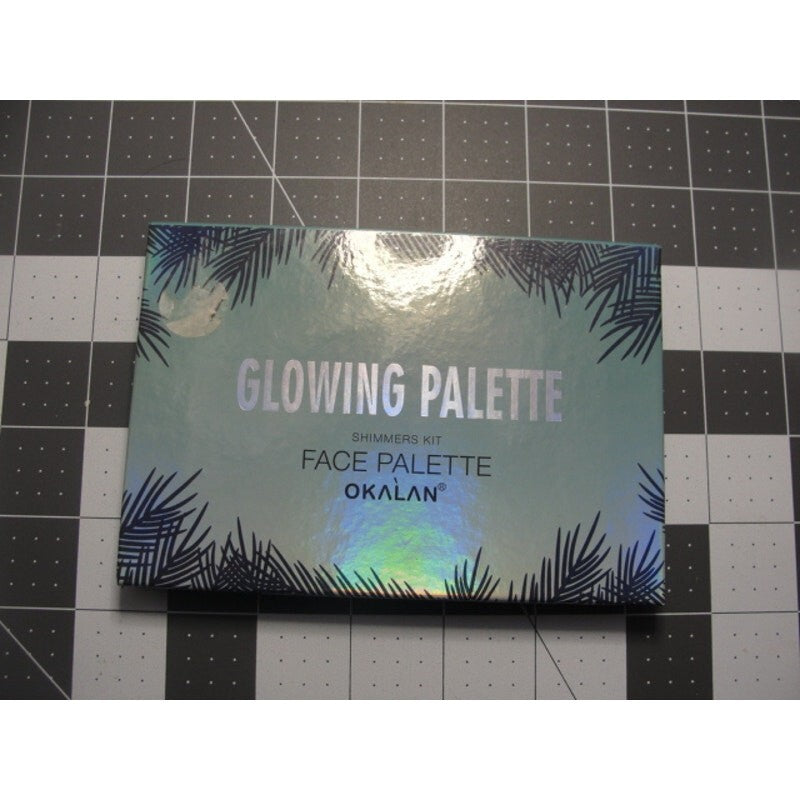 Okalan Glowing Face Palette B shimmers kit in a holographic packaging
