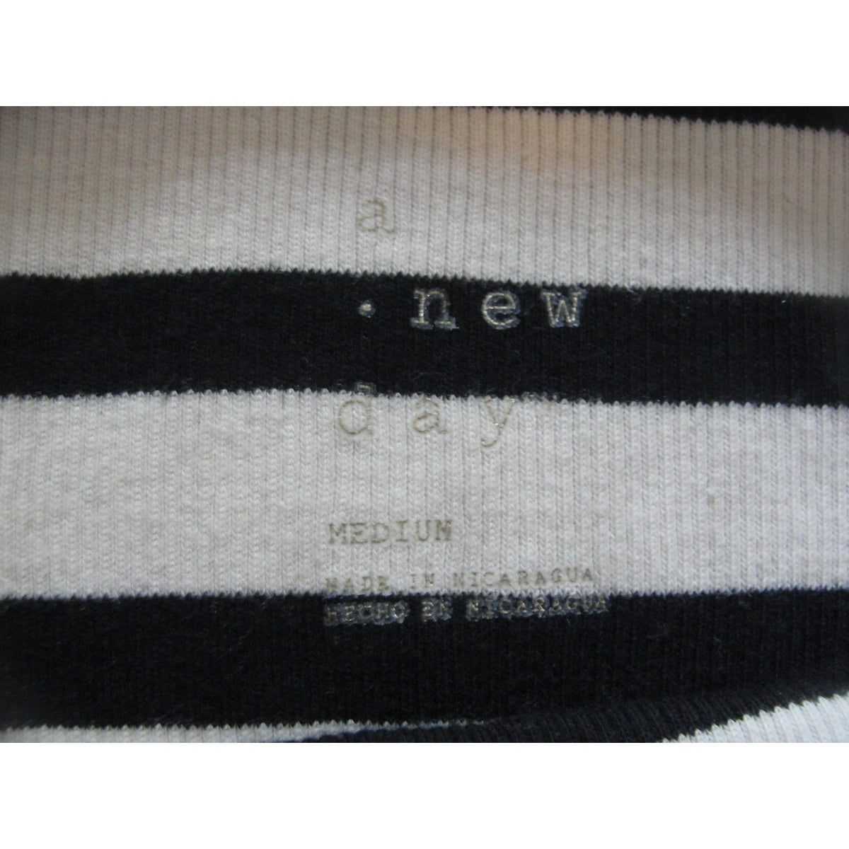 A new day striped tank top featuring a cream-colored trim size medium