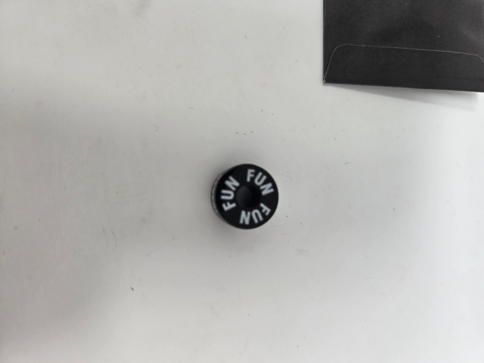 Fun Brand Black Button Pin with 'FUN' Text and 'The Reveal' Sleeve