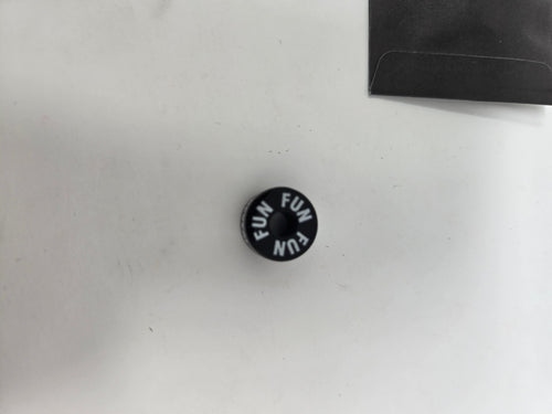 Fun Brand Black Button Pin with 'FUN' Text and 'The Reveal' Sleeve