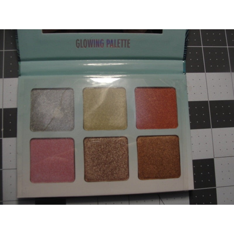 Okalan Glowing Face Palette B shimmers kit in a holographic packaging